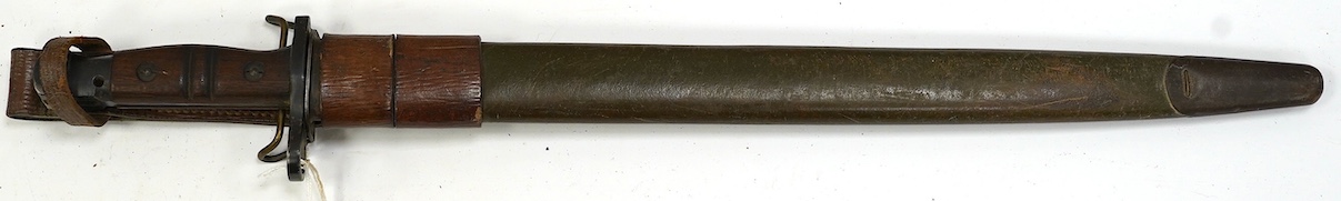 An American 1917 Remington bayonet, based on the earlier British bayonet of 1913, adapted for the 0.3 to 0.6 calibre rifles, with its leather covered scabbard. Condition - good